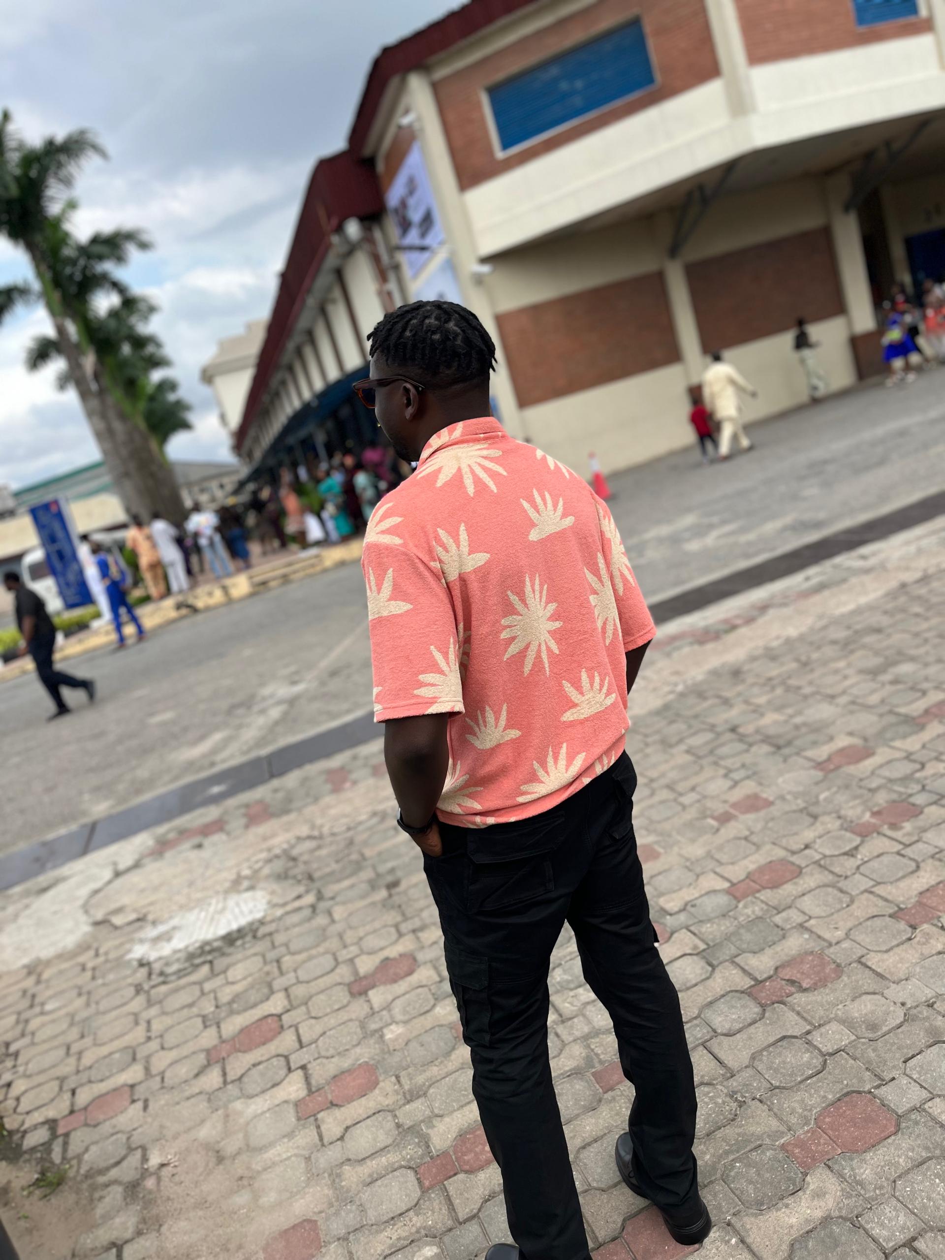 Desmond walking down a street, seen from behind